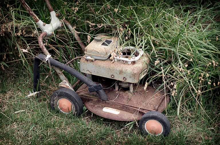 old rusted lawn mower that needs to be recycled