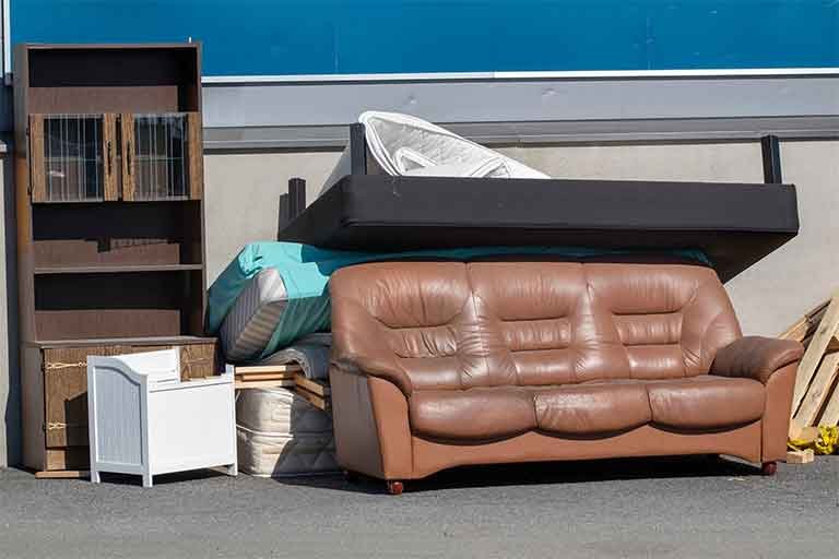 pile of old furniture awaiting furniture removal service from Garbage Gurus