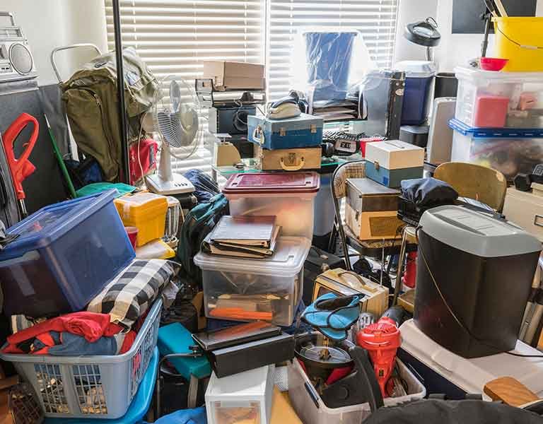 cluttered storage room in home ready for hoarder junk removal service