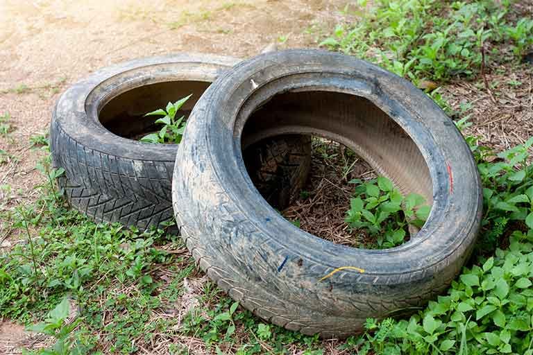 rubber tires on ground awaiting tire disposal service from Garbage Gurus
