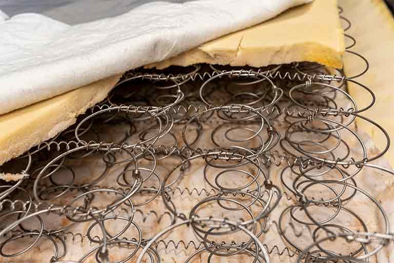 box spring recycling with layers of fabric, foam, and metal springs
