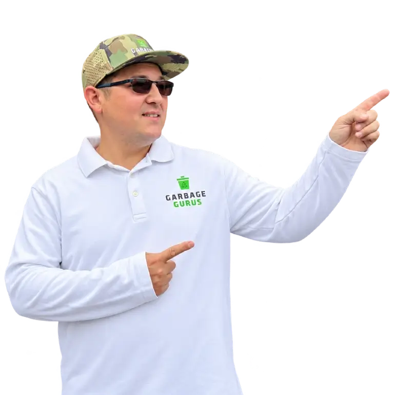 Joshua Caron, co-owner of Garbage Gurus pointing to the right