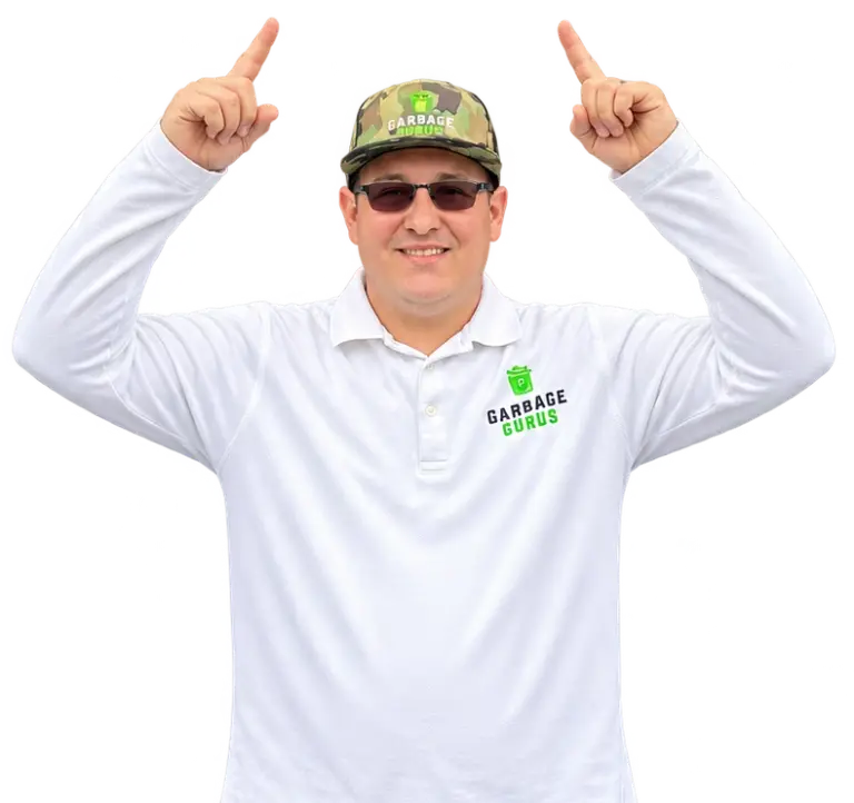 Joshua Caron, co-owner of Garbage Gurus pointing upwards