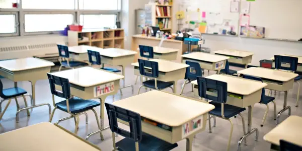 Inside of classroom with empty desks representing junk removal service for schools, colleges, and childcare facilities