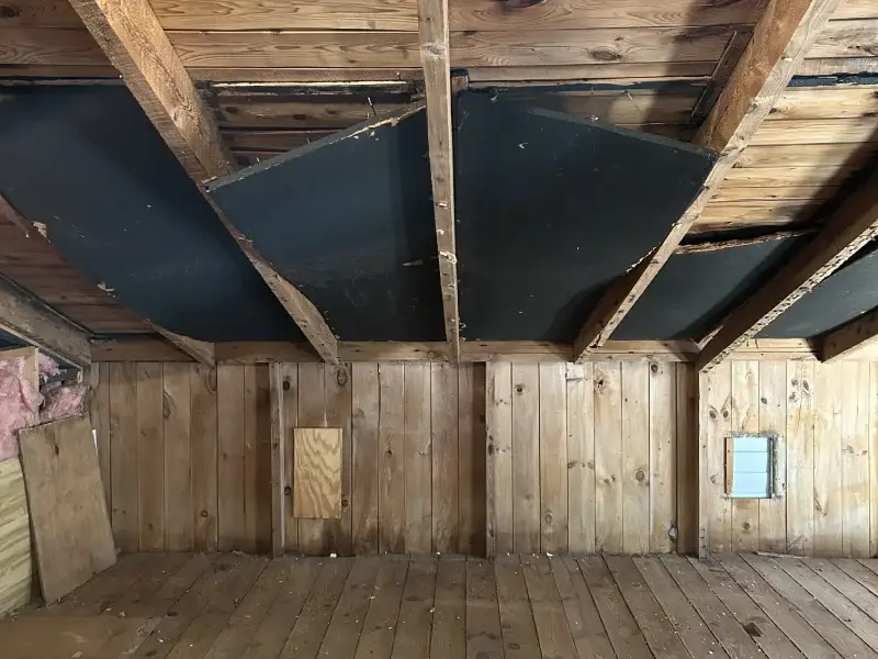 Old attic space that is clear of accumulated junk, after attic cleanout service from Garbage Gurus