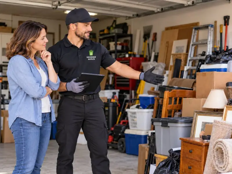 Garbage Gurus junk removal technician consulting with a homeowner about their garage cleanout service options