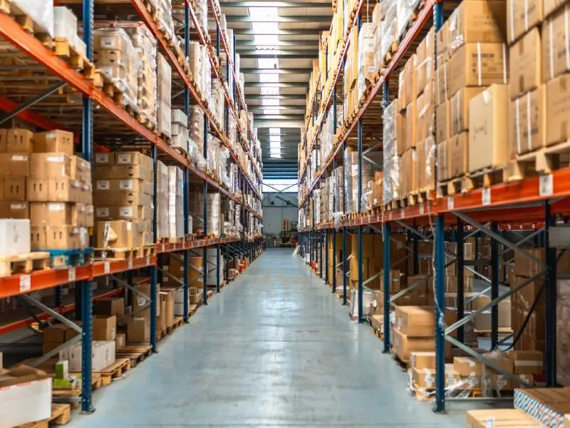 warehouse with stocked industrial shelves representing warehouse cleanout service for factories and supply houses in North Central MA